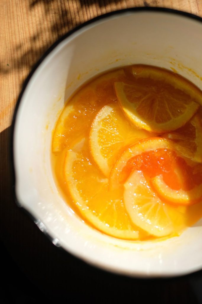 Citrus slices cooking in syrup