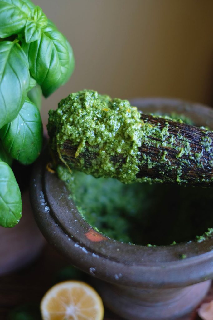 basil pesto using a pestle and mortar