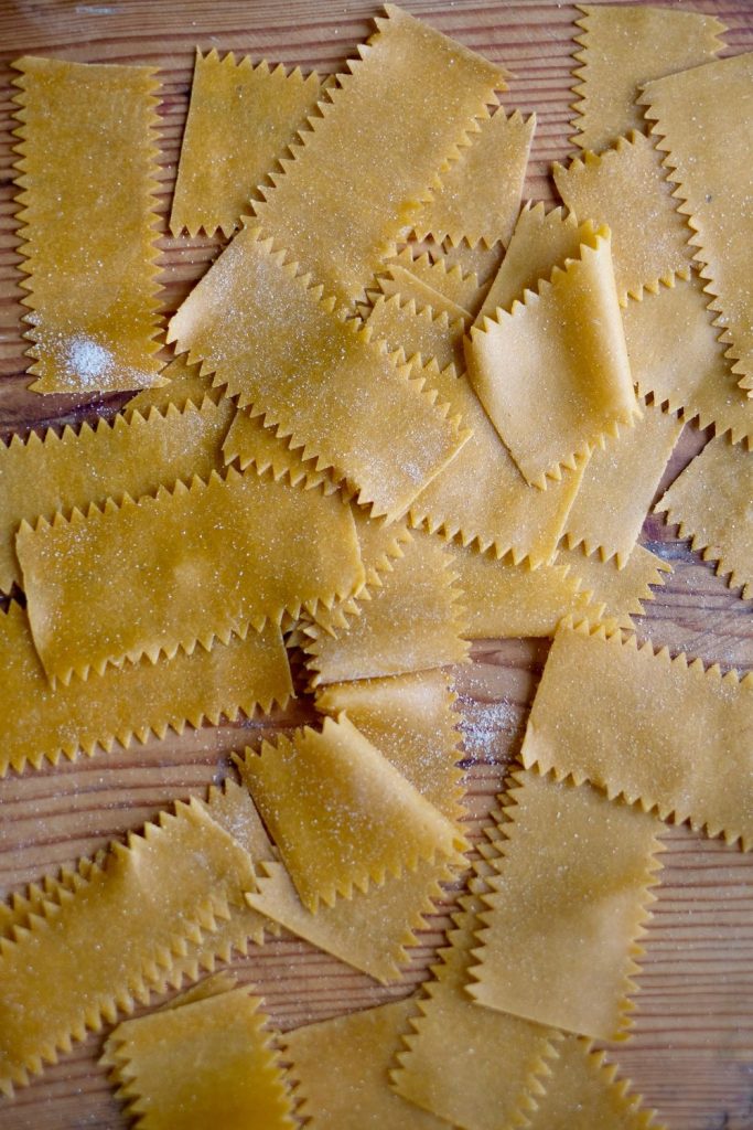 cutting fazzoletti pasta with a pasta cutter