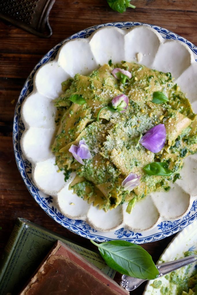 Pesto Fazzoletti Pasta topped with parmesan and edible flowers