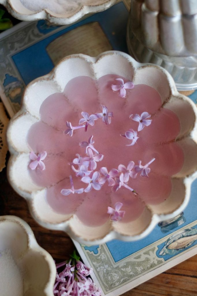 Simple Lilac Syrup in a bowl with lilac blossoms